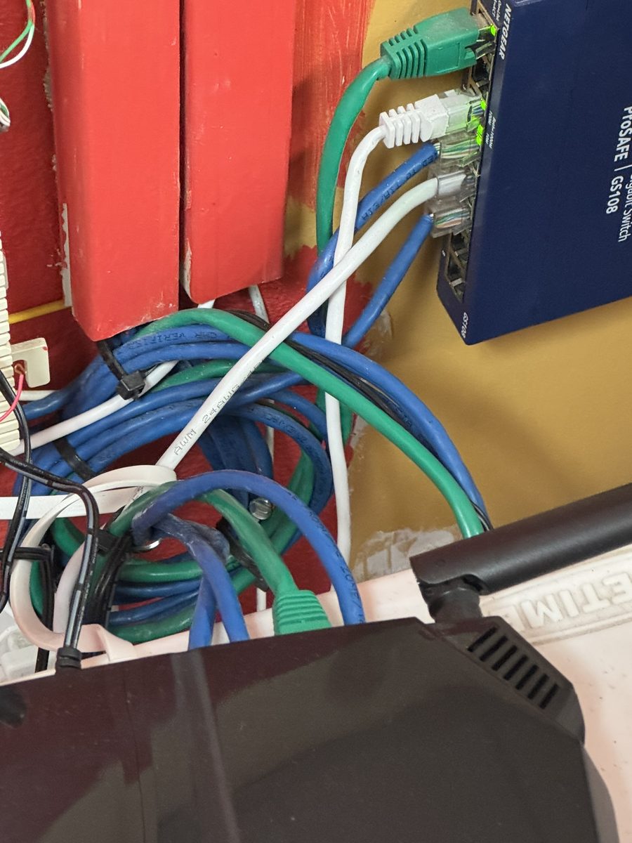 Network switch with Ethernet cables connected and port indicator lights active